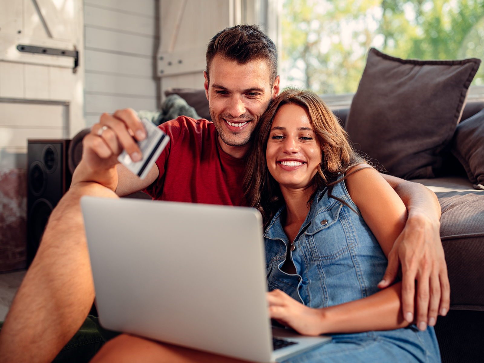 couple sitting together looking at laptop happily