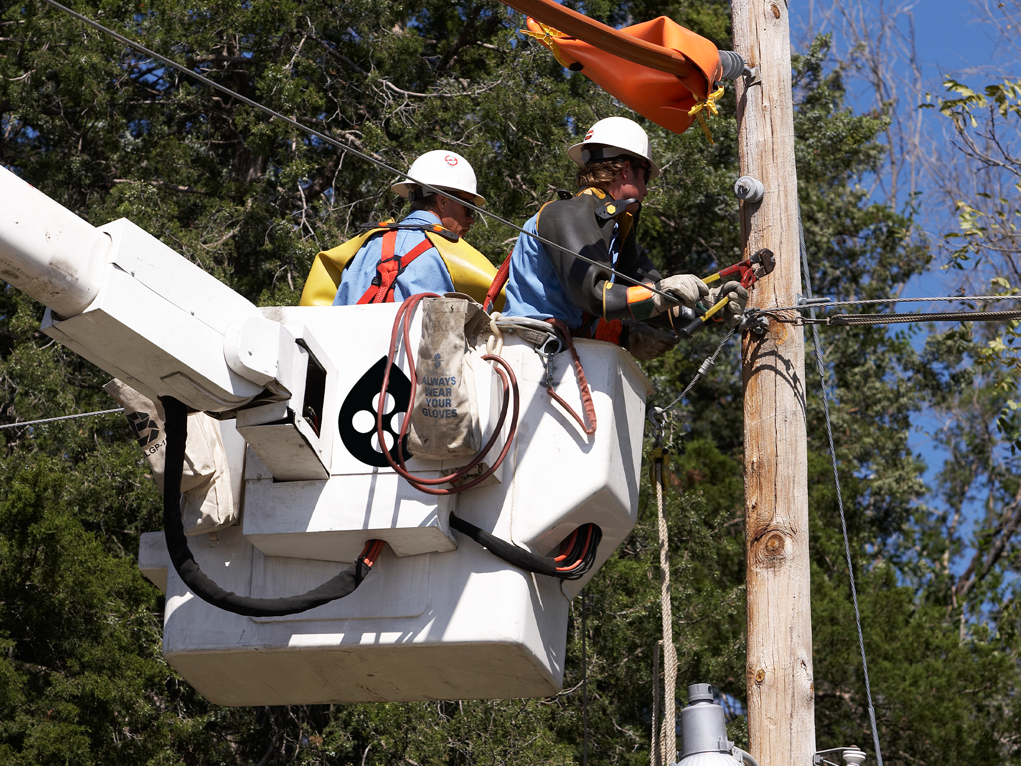 men working on electric pole in bucket