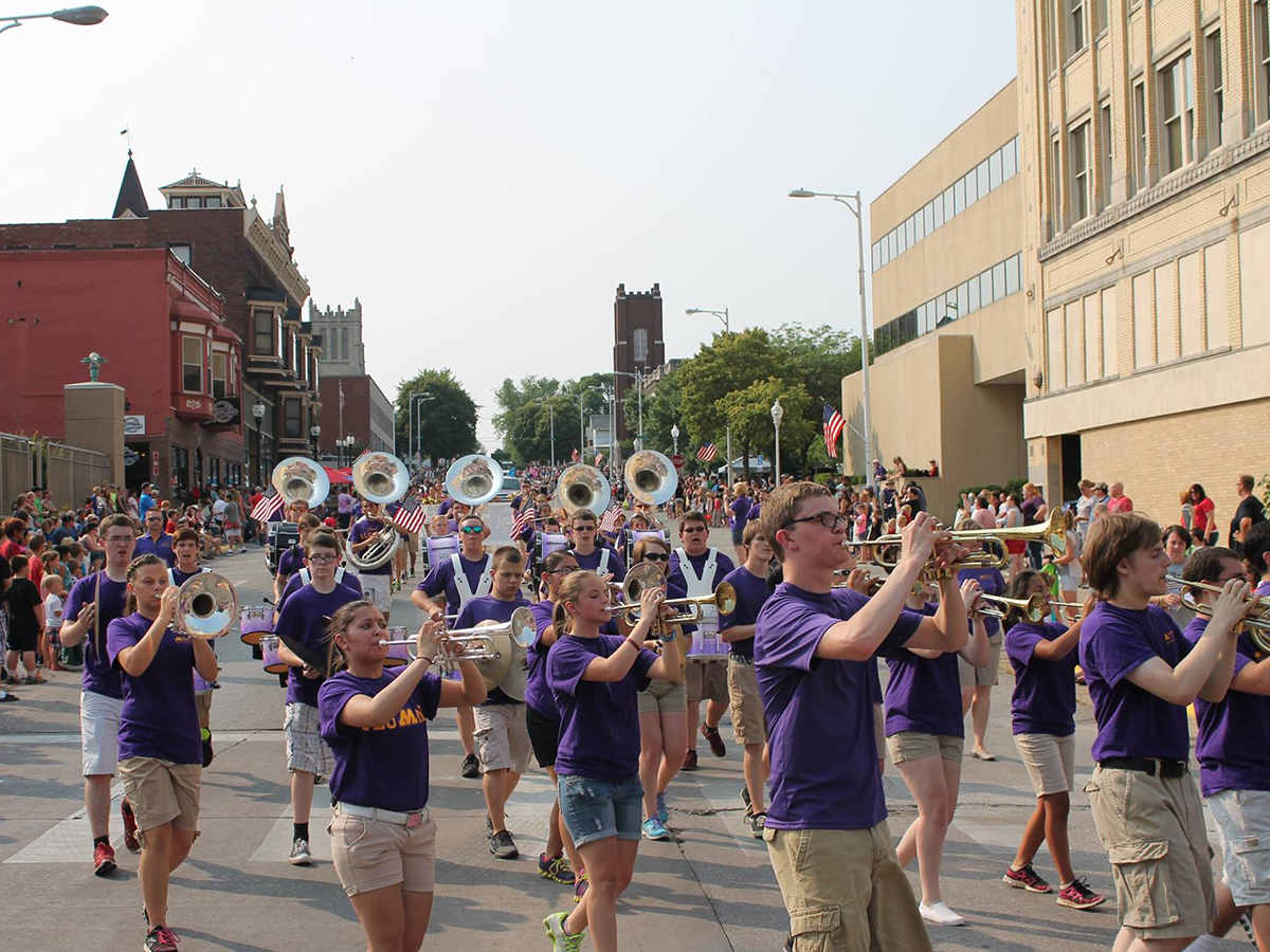 marching band walking streets of downtown muscatine