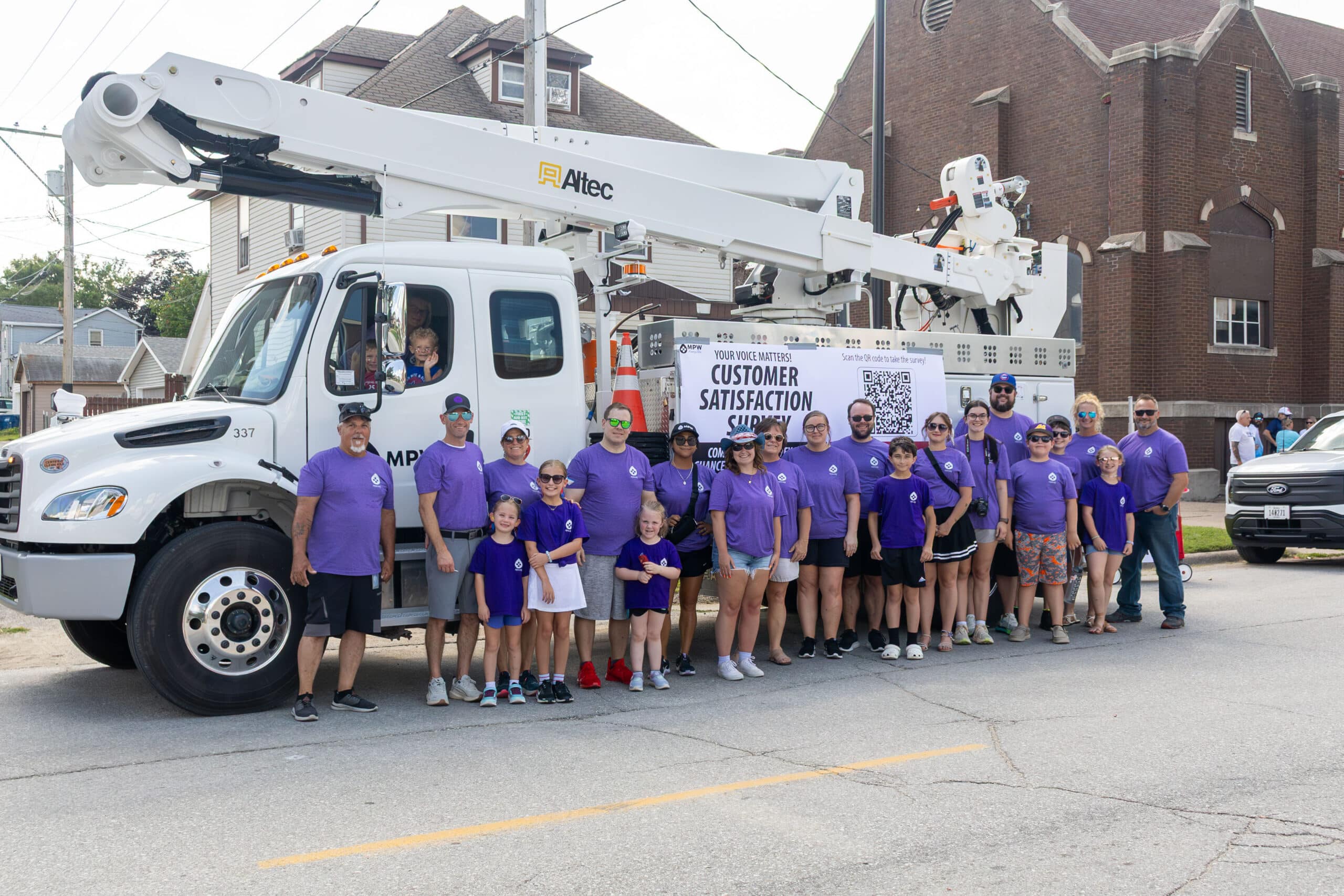 MPW staff walking in the 2025 4th of July parade posed in front of MPW truck