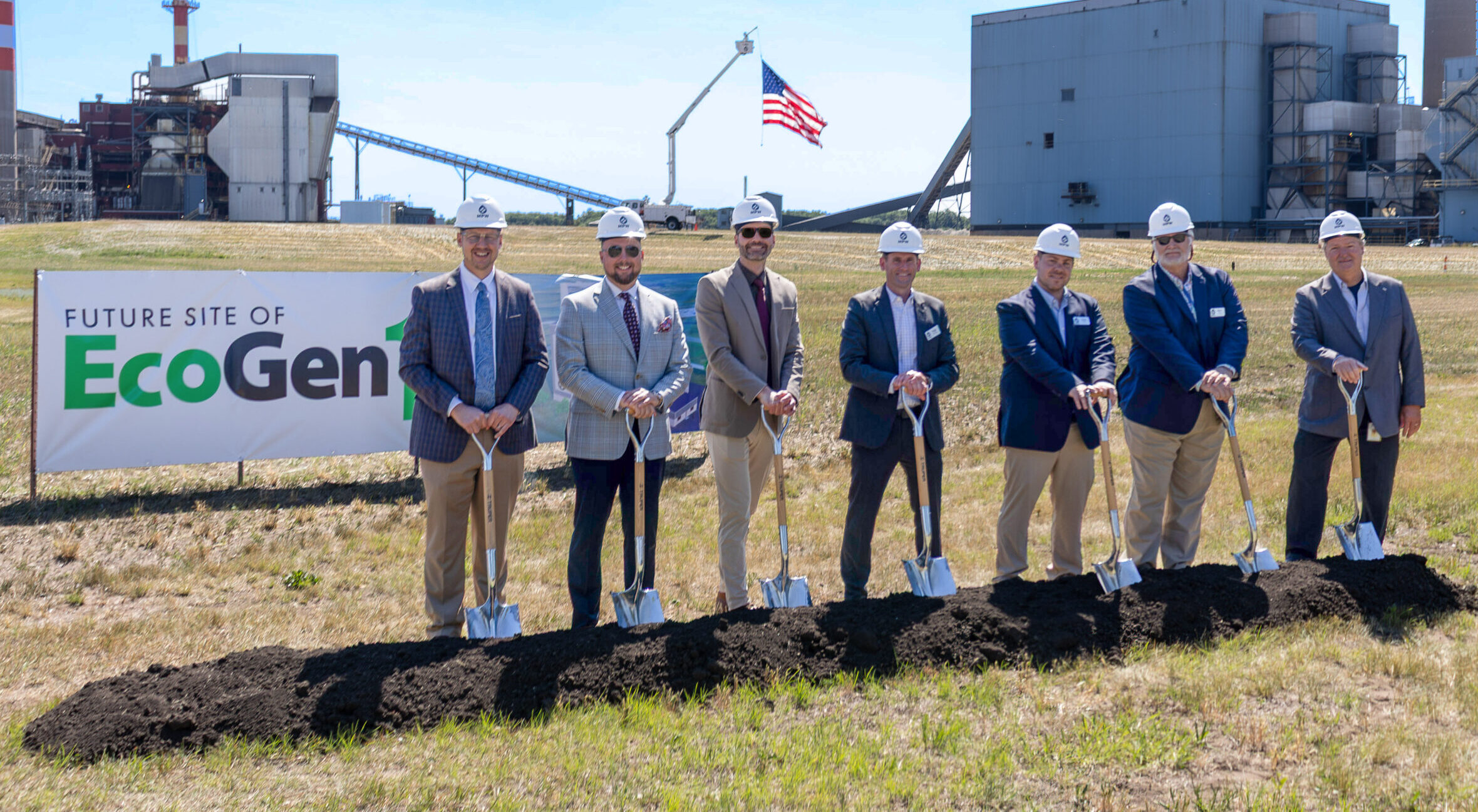 People with hardhats and shoves at groundbreaking event
