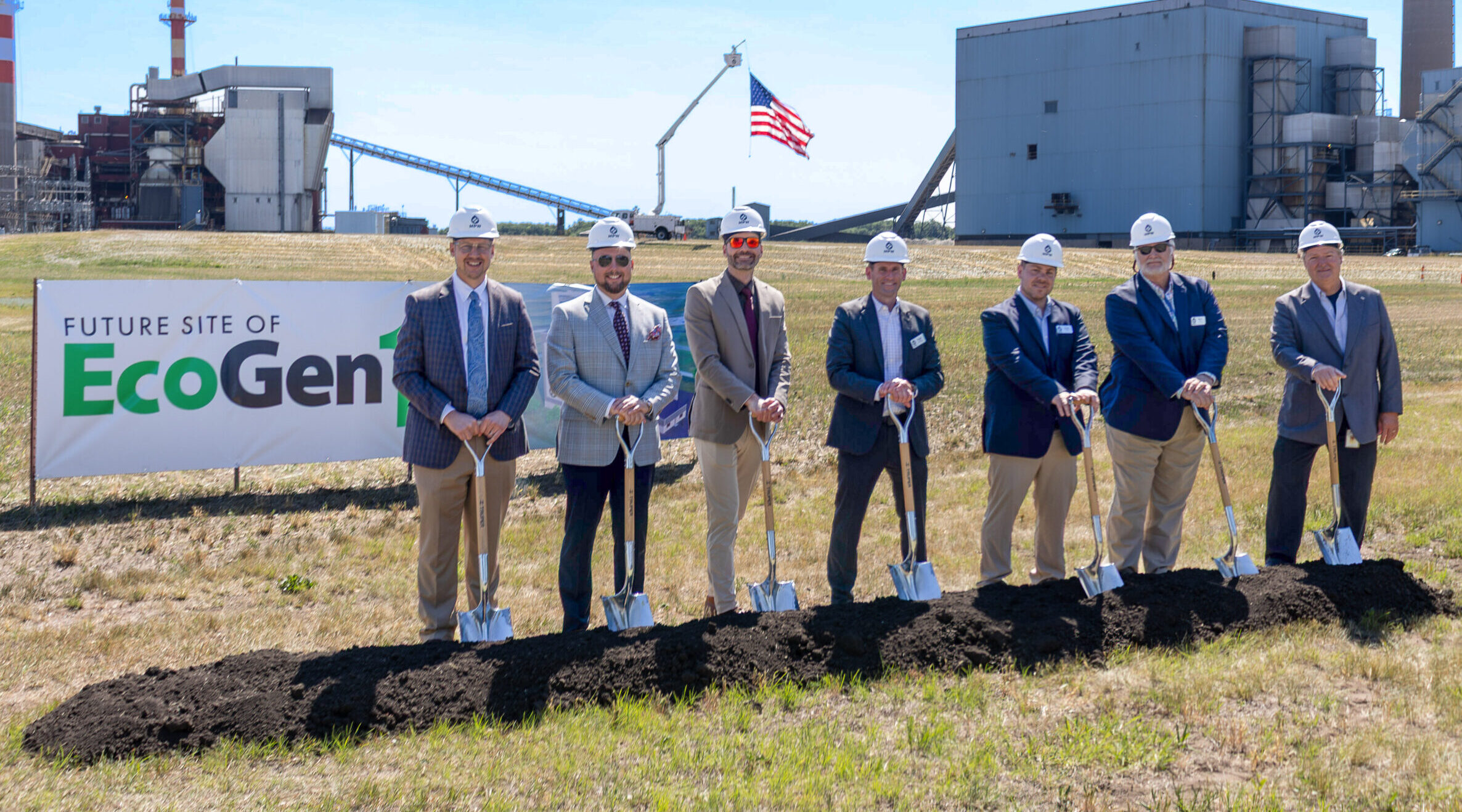 People with hardhats and shoves at groundbreaking event