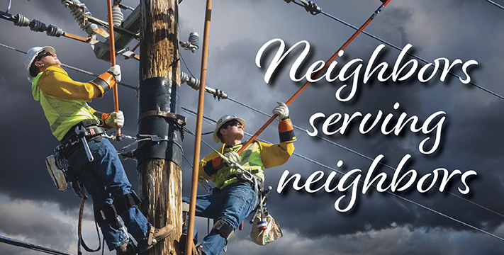 two linemen on a power pole