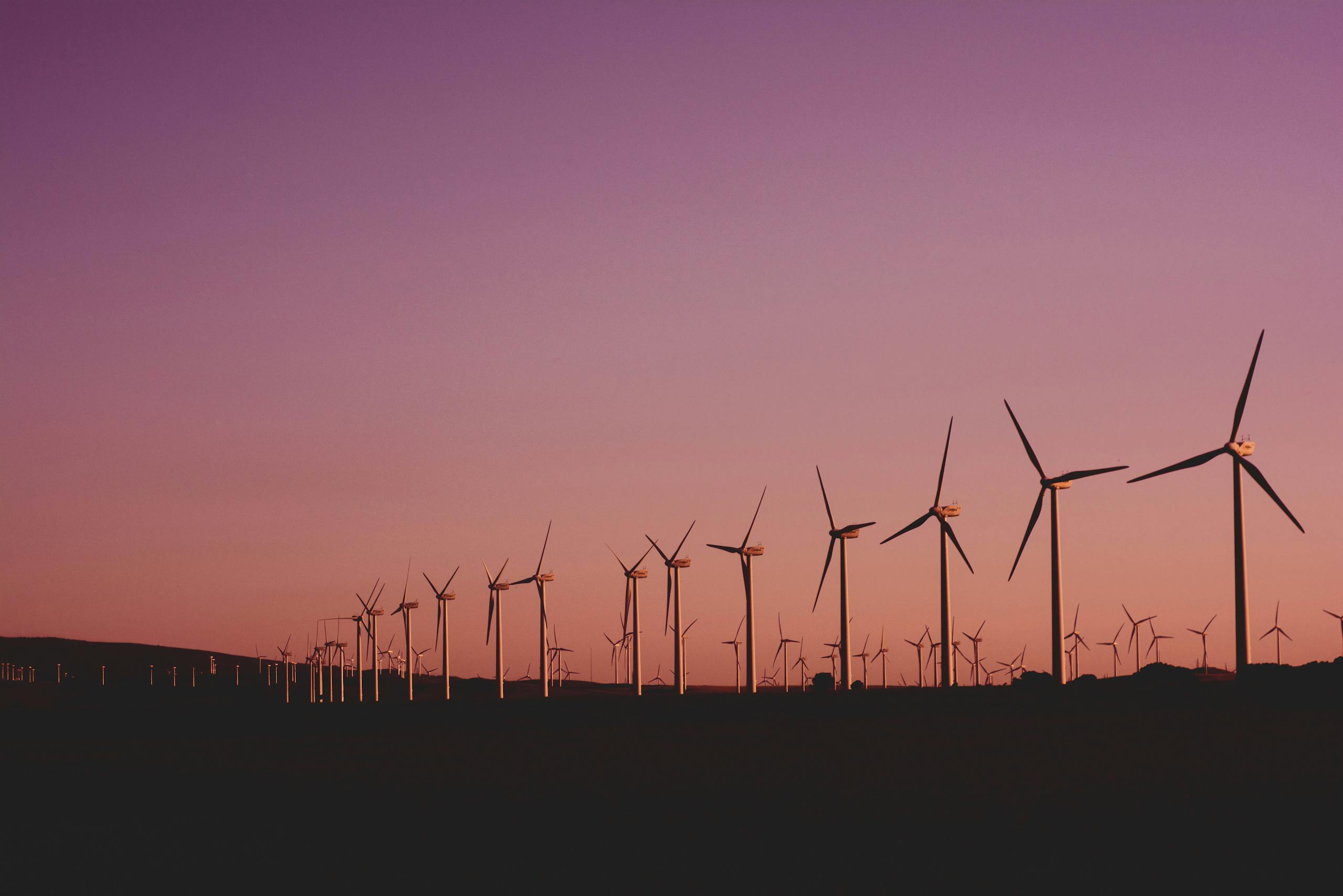 Silhouetted wind turbines at sunset in Zahara de los Atunes, Spain.