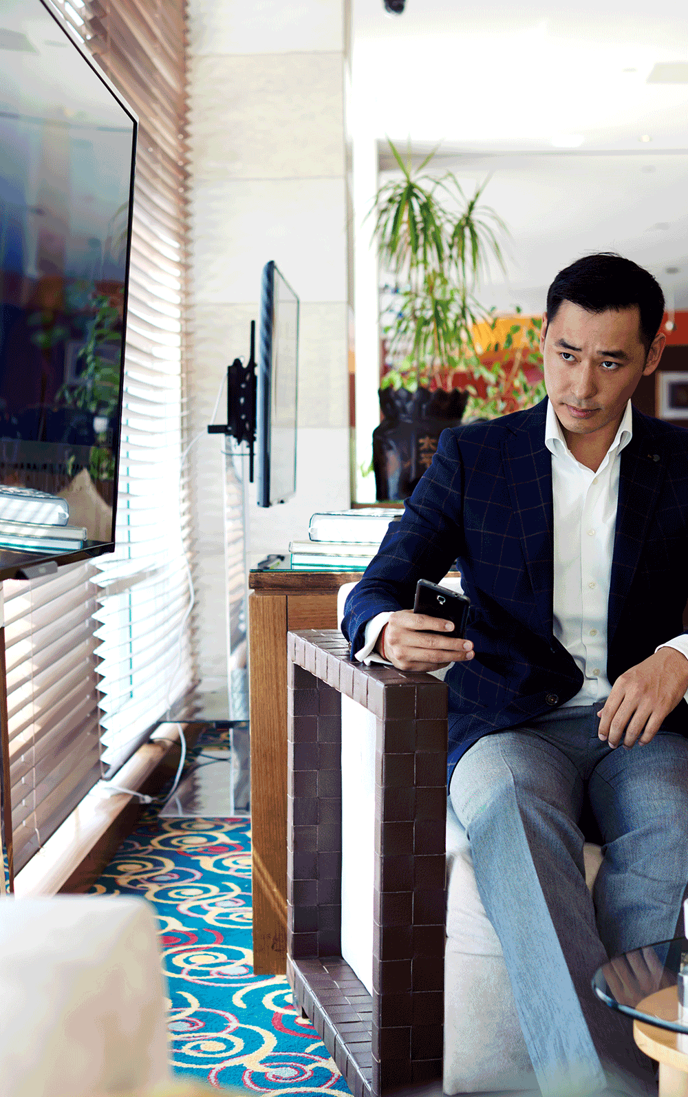 a man watching tv in a hotel lobby